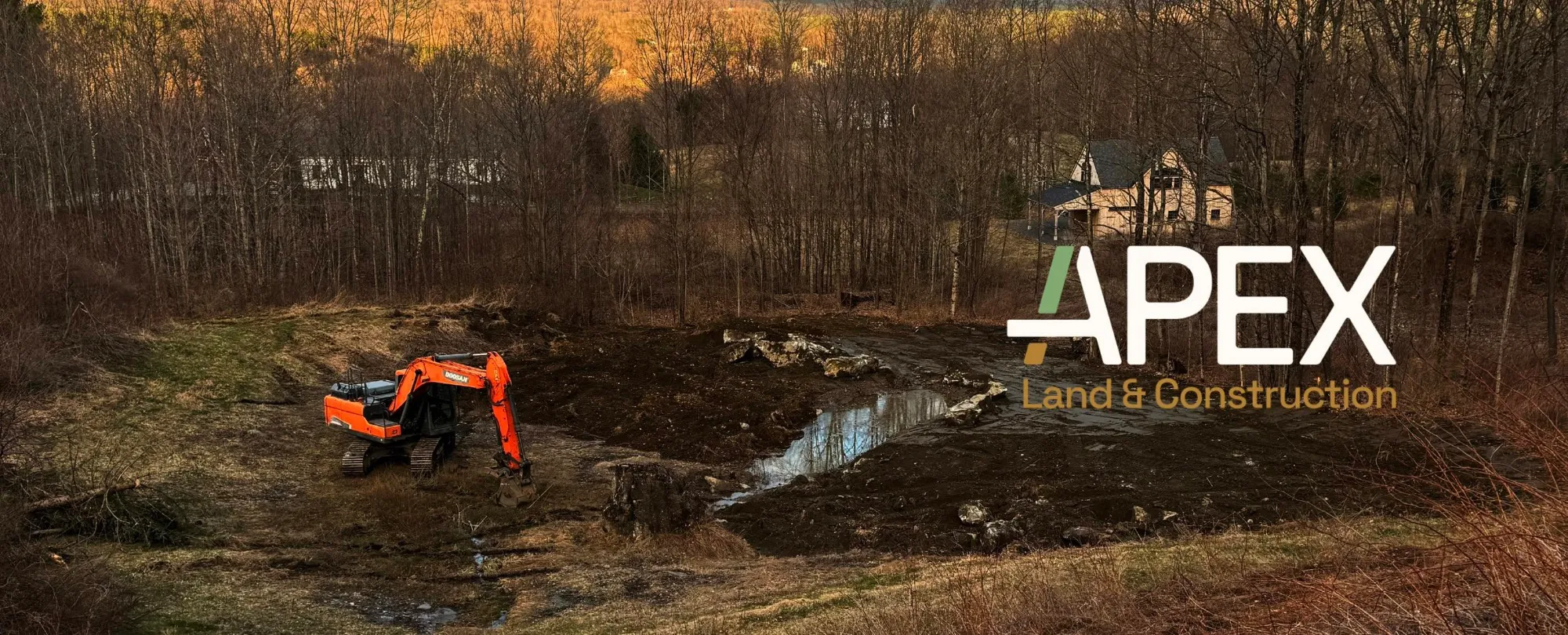 Excavator clearing and grading land for a new project