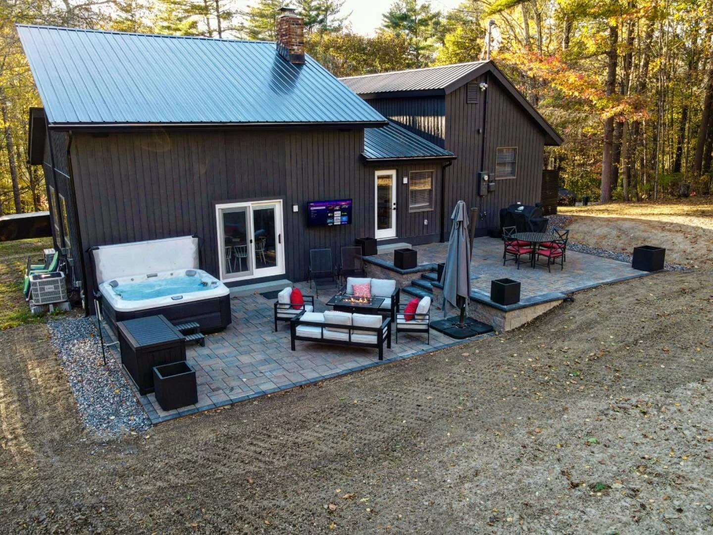 Two-level paver patio with hot tub, fire table and dining area